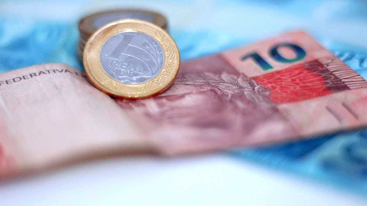 A coin sitting on top of a pile of money