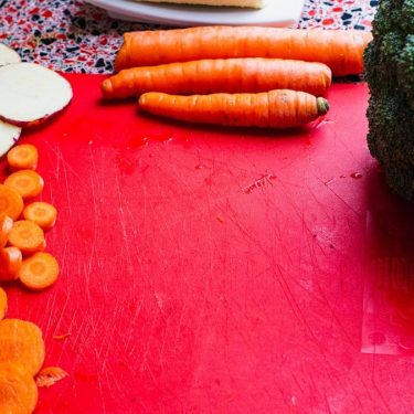 sliced carrots on red board